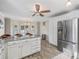 Spacious kitchen with stainless steel refrigerator and a dining area with natural light and views at 1501 Lavaca Ln, The Villages, FL 32159