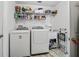 Functional laundry room with washer, dryer, and ample storage space at 1501 Lavaca Ln, The Villages, FL 32159