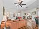 Inviting living room with hardwood floors, leather sofa, stylish decor, and plenty of natural light at 1501 Lavaca Ln, The Villages, FL 32159