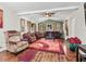 Inviting living room featuring hardwood floors, natural light, and a decorative ceiling fan at 1501 Lavaca Ln, The Villages, FL 32159