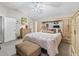 Neutral main bedroom with an ensuite bathroom, large closet space, and large bed at 1501 Lavaca Ln, The Villages, FL 32159