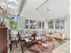 Bright sunroom with large windows, comfortable seating, and plenty of natural light at 1501 Lavaca Ln, The Villages, FL 32159