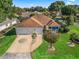 Charming home featuring a well-manicured lawn, decorative driveway, and attached two-car garage at 1501 Lavaca Ln, The Villages, FL 32159