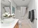 Bright bathroom features a modern glass bowl sink, updated fixtures, and a tub-shower combo at 1502 Blueberry Way, The Villages, FL 32162