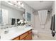 Bright bathroom features a modern glass bowl sink, updated fixtures, and a tub-shower combo at 1502 Blueberry Way, The Villages, FL 32162