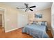Bedroom featuring ceiling fan, wood floors, and plantation shutters at 1502 Blueberry Way, The Villages, FL 32162