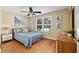 Bedroom with natural light, wood floors, and coastal decor at 1502 Blueberry Way, The Villages, FL 32162