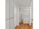 Walk in closet featuring wood floors and built-in shelves at 1502 Blueberry Way, The Villages, FL 32162