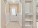 Bright entryway with decorative trim, tiled floor, and built-in shelving at 1502 Blueberry Way, The Villages, FL 32162