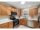 Charming kitchen with stainless steel appliances and white countertops, perfect for culinary enthusiasts at 1502 Blueberry Way, The Villages, FL 32162