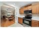Efficient kitchen layout with stainless steel microwave and oven, seamlessly connected to the dining area at 1502 Blueberry Way, The Villages, FL 32162
