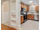 Bright kitchen with stainless steel appliances, wooden cabinets, and tile flooring at 1502 Blueberry Way, The Villages, FL 32162