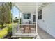 Inviting covered patio features white pergola, seating, and access to the home's rear entrance at 1502 Blueberry Way, The Villages, FL 32162