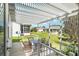 Covered patio with dining set and views of the green backyard at 1502 Blueberry Way, The Villages, FL 32162