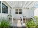 Exterior view of the covered patio with dining set and views of the backyard at 1502 Blueberry Way, The Villages, FL 32162