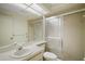 Tidy bathroom with a single sink vanity, toilet, and a sliding-door shower at 1512 S Pointe Dr, Leesburg, FL 34748