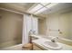 Well-maintained bathroom with a shower-tub combination, a large mirror, and vanity sink at 1512 S Pointe Dr, Leesburg, FL 34748