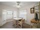 Cozy dining area with a ceiling fan and bright window at 1512 S Pointe Dr, Leesburg, FL 34748