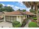 Charming single-story home featuring a well-manicured lawn, attached garage and welcoming curb appeal at 1512 S Pointe Dr, Leesburg, FL 34748