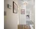 Bright hallway with neutral walls, artwork, and carpet that leads to the main living areas at 1512 S Pointe Dr, Leesburg, FL 34748