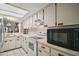 Well-lit kitchen featuring white appliances, ample cabinet space, and an open layout at 1512 S Pointe Dr, Leesburg, FL 34748
