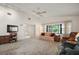 Cozy living room with ceiling fan, and large windows at 1512 S Pointe Dr, Leesburg, FL 34748