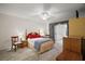 Comfortable main bedroom featuring soft carpet flooring and a ceiling fan at 1512 S Pointe Dr, Leesburg, FL 34748