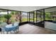 Inviting screened porch with tile flooring and views of the landscaped backyard at 1512 S Pointe Dr, Leesburg, FL 34748