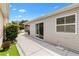 Concrete back patio features sliding glass doors and a window into the main part of the house at 1513 Lozano Ave, The Villages, FL 32159