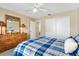 Charming bedroom with a wooden dresser, sliding door closet and neutral carpeting at 1513 Lozano Ave, The Villages, FL 32159