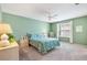 Comfortable bedroom with a queen size bed, soft carpet, and natural light at 1513 Lozano Ave, The Villages, FL 32159
