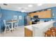 Bright kitchen with white countertops, stainless steel appliances, and breakfast bar seating at 1513 Lozano Ave, The Villages, FL 32159