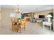 Open-concept living and dining area with tiled floors, a dining table, and comfortable seating at 1513 Lozano Ave, The Villages, FL 32159