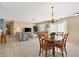 Bright and airy living and dining area with tile flooring, a chandelier, and comfortable sofas at 1513 Lozano Ave, The Villages, FL 32159