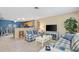 Comfortable living room with blue accents, tile floors, and an open view to the breakfast area at 1513 Lozano Ave, The Villages, FL 32159