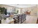 Inviting living space with plaid sofas, tile flooring, and a dining area, perfect for relaxing and entertaining at 1513 Lozano Ave, The Villages, FL 32159