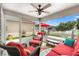 Enjoy the screened lanai with comfortable seating and lovely views of the outdoors at 1513 Lozano Ave, The Villages, FL 32159