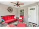 Relaxing screened porch with comfortable wicker furniture, a ceiling fan, and an inviting atmosphere at 1513 Lozano Ave, The Villages, FL 32159