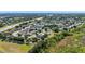 An aerial view of a residential neighborhood with houses, green spaces, and a highway at 15501 Markham Dr, Clermont, FL 34714