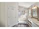 Modern bathroom featuring a glass-enclosed shower, white cabinets and tile at 15501 Markham Dr, Clermont, FL 34714