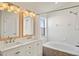 Bright bathroom with dual vanity, mosaic tile accents, and tub-shower combo at 15501 Markham Dr, Clermont, FL 34714