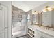 Modern bathroom featuring a glass-enclosed shower and double vanity at 15501 Markham Dr, Clermont, FL 34714