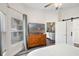 Comfortable bedroom with dresser, TV, and view to living area through sliding barn door and open doorway at 15501 Markham Dr, Clermont, FL 34714