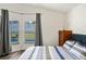 Comfortable bedroom with wood-look floors, and sunlit view of the pool at 15501 Markham Dr, Clermont, FL 34714