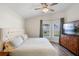Comfortable bedroom with ensuite, including a large bed, dresser, and natural light from a bay window at 15501 Markham Dr, Clermont, FL 34714