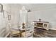 Dining room featuring a glass table, four chairs, a decorative chandelier, and wood-look floors at 15501 Markham Dr, Clermont, FL 34714