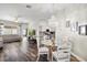 Open-concept design showing dining room, kitchen, and living room with wood-look floors and modern decor at 15501 Markham Dr, Clermont, FL 34714