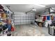 Spacious garage with ample storage, an open garage door, and concrete flooring at 15501 Markham Dr, Clermont, FL 34714