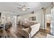 Inviting living room featuring wood floors, neutral paint, and stylish furnishings with views of the dining area at 15501 Markham Dr, Clermont, FL 34714