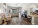 Spacious living room with hardwood floors, sectional sofa, entertainment center, and lots of light at 15501 Markham Dr, Clermont, FL 34714